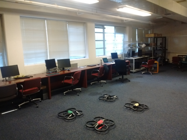 4 Drones sitting in lab getting ready to takeoff