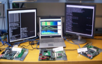 Computers connected to microcontrollers are displaying data over 3 monitors